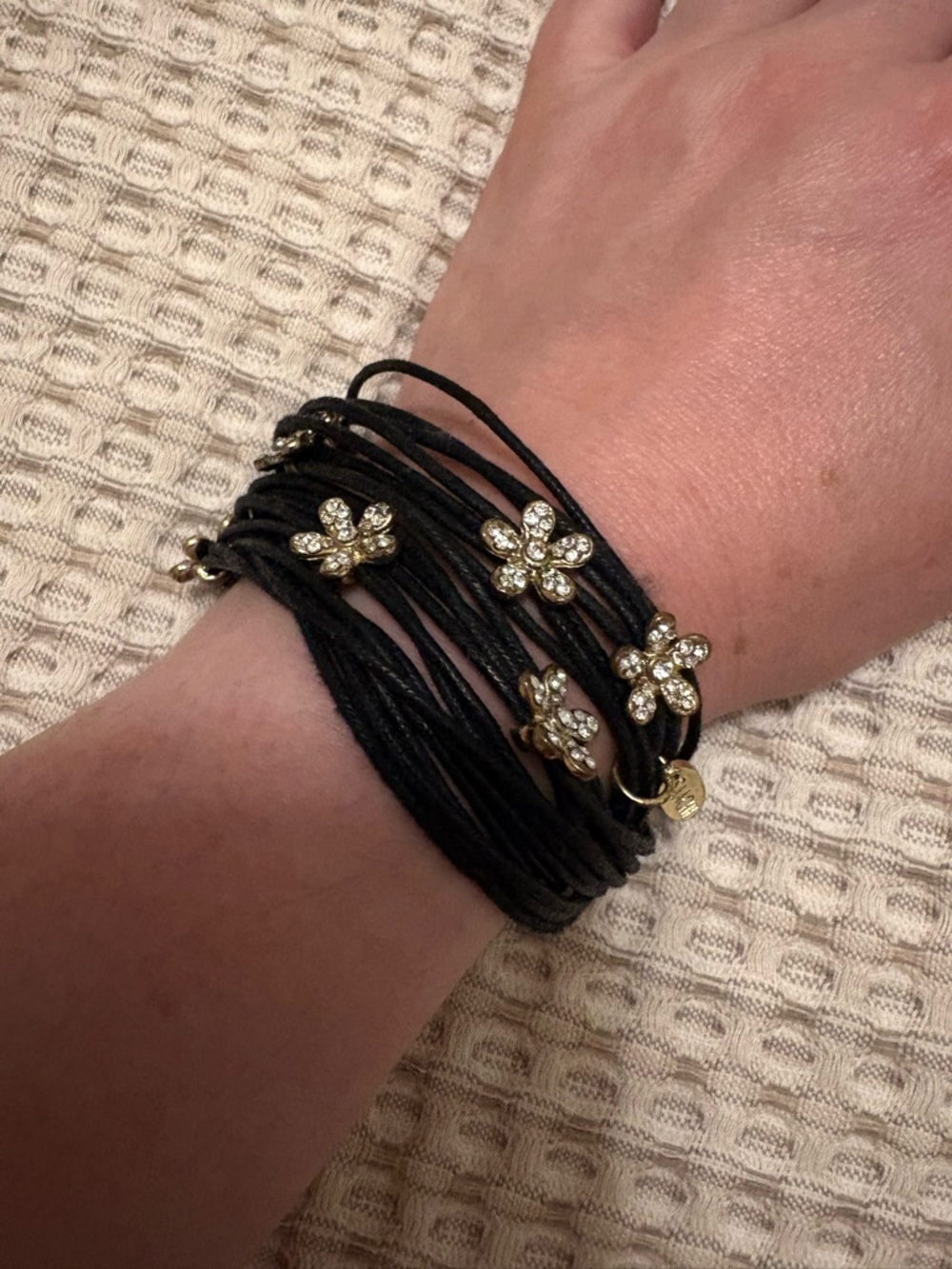 Black Multi-Strand Cord Bracelet with Gold Crystal Flower Accents